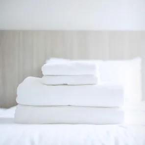 White sheets on a made bed